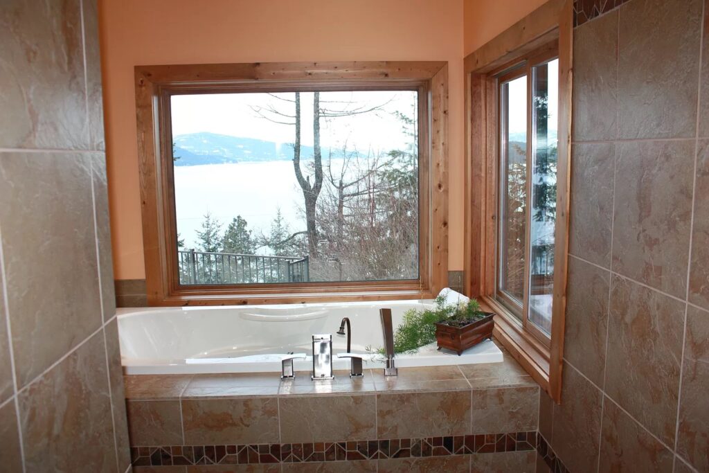 luxury bath tub with a view of the lake